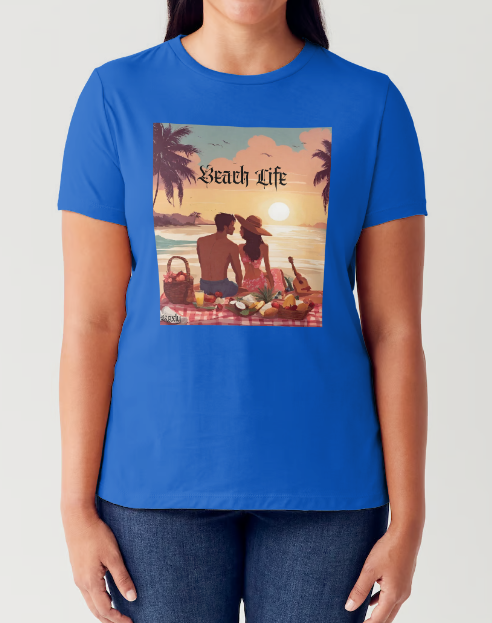 "Embrace adventure in our "Beach Life" cotton tee! This Women's T-shirt is featuring a relaxed fit that transports you to a tropical paradise with its picnic scene of a couple enjoying the sunset over the ocean. Bring the beach life with you wherever you go!" Available in Blue or Black colors. This is part of the Mike Roxly Collection.