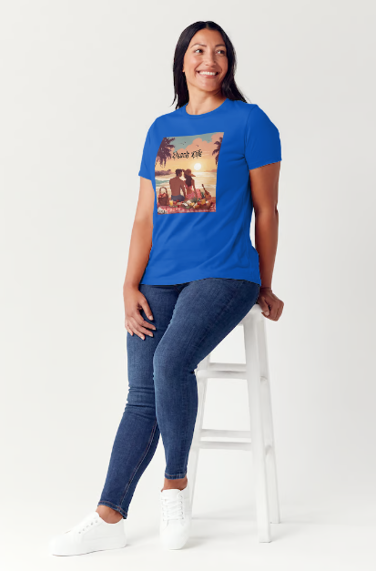 "Embrace adventure in our "Beach Life" cotton tee! This Women's T-shirt is featuring a relaxed fit that transports you to a tropical paradise with its picnic scene of a couple enjoying the sunset over the ocean. Bring the beach life with you wherever you go!" Available in Blue or Black colors. This is part of the Mike Roxly Collection.