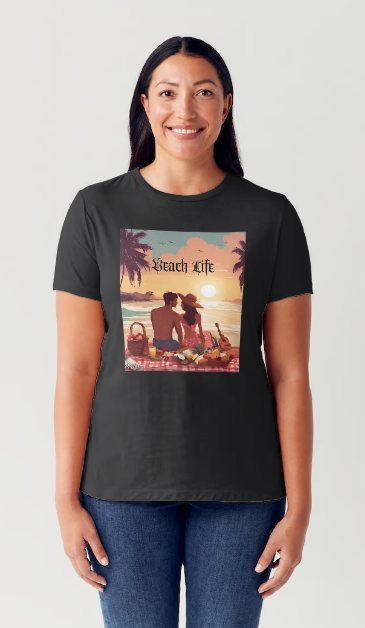 "Embrace adventure in our "Beach Life" cotton tee! This Women's T-shirt is featuring a relaxed fit that transports you to a tropical paradise with its picnic scene of a couple enjoying the sunset over the ocean. Bring the beach life with you wherever you go!" Available in Blue or Black colors. This is part of the Mike Roxly Collection.