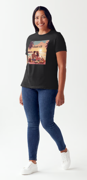 "Embrace adventure in our "Beach Life" cotton tee! This Women's T-shirt is featuring a relaxed fit that transports you to a tropical paradise with its picnic scene of a couple enjoying the sunset over the ocean. Bring the beach life with you wherever you go!" Available in Blue or Black colors. This is part of the Mike Roxly Collection.