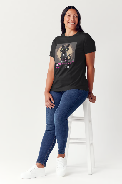 "The 'Keep Stepping Bitch' t-shirt packs a punch with its sassy black cat and bold pink lightning bolt design. Complete with punk/gothic boots, lucky dice, and sexy red cherries, this shirt exudes confidence and attitude. Perfect for those who are unapologetically themselves. Get ready to step up your style game." Available in Black color t-shirt and sizes small through XX-Large. This is part of the Mike Roxly Collection.
