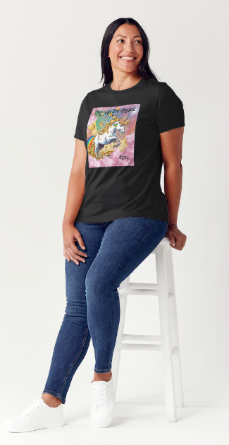 This is a black t-shirt entitled "they say I'm magical", features a White unicorn with a blinding light from its' horn, a golden mane and a rainbow tail galloping through cotton candy pink clouds filled with raining golden coins and a multicolor background. This shirt is for the bold unapologetically yourself type. YOLO. This is part of the Mike Roxly Collection.