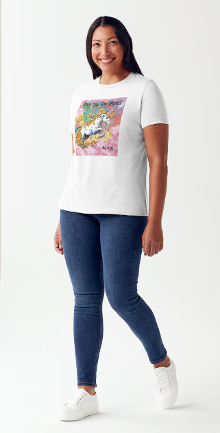 This is a black t-shirt entitled "they say I'm magical", features a White unicorn with a blinding light from its' horn, a golden mane and a rainbow tail galloping through cotton candy pink clouds filled with raining golden coins and a multicolor background. This shirt is for the bold unapologetically yourself type. YOLO. This is part of the Mike Roxly Collection.