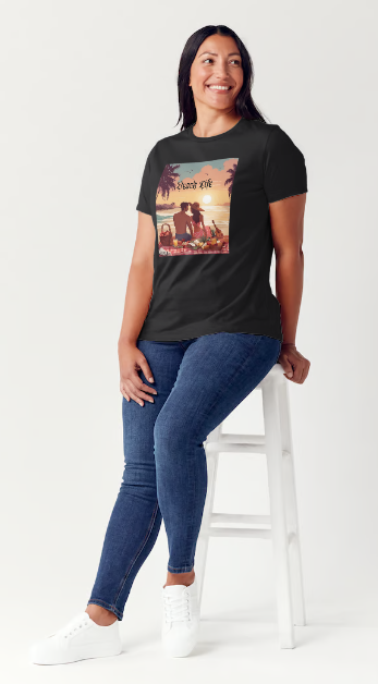 "Embrace adventure in our "Beach Life" cotton tee! This Women's T-shirt is featuring a relaxed fit that transports you to a tropical paradise with its picnic scene of a couple enjoying the sunset over the ocean. Bring the beach life with you wherever you go!" Available in Blue or Black colors. This is part of the Mike Roxly Collection.
