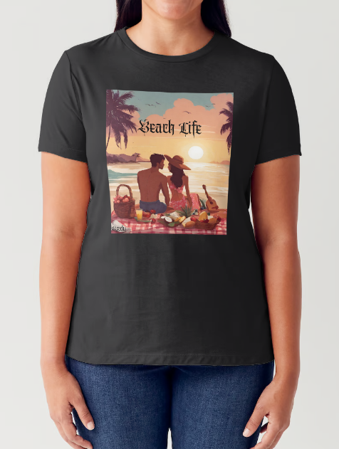 "Embrace adventure in our "Beach Life" cotton tee! This Women's T-shirt is featuring a relaxed fit that transports you to a tropical paradise with its picnic scene of a couple enjoying the sunset over the ocean. Bring the beach life with you wherever you go!" Available in Blue or Black colors.  This is part of the Mike Roxly Collection.