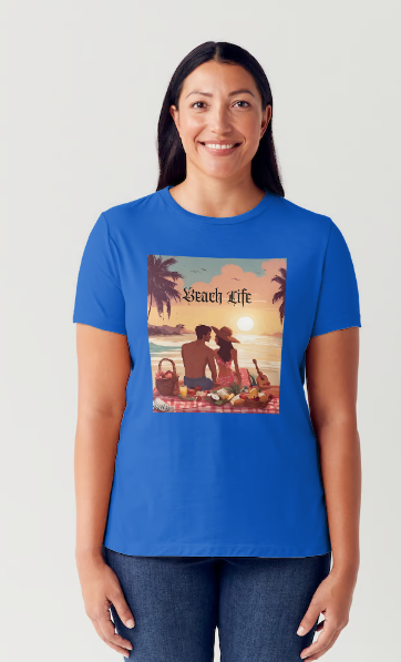 "Embrace adventure in our "Beach Life" cotton tee! This Women's T-shirt is featuring a relaxed fit that transports you to a tropical paradise with its picnic scene of a couple enjoying the sunset over the ocean. Bring the beach life with you wherever you go!" Available in Blue or Black colors.  This is part of the Mike Roxly Collection.