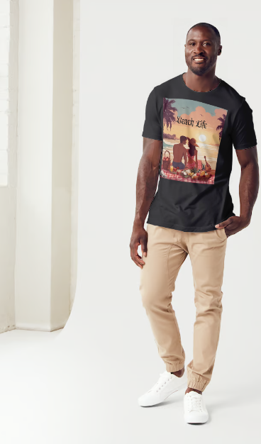 This is a model wearing a t-shirt entitled "Beach Life" men's graphic t-shirt. The shirt itself is black in color. Made of soft and breathable cotton, this shirt embodies the perfect beach day with a romantic scene full of warm colors, it features a couple enjoying a sunset picnic surrounded by palm trees by the ocean. Let the bold design and adventurous spirit inspire your next adventure!" This is a Mike Roxly collection T-shirt