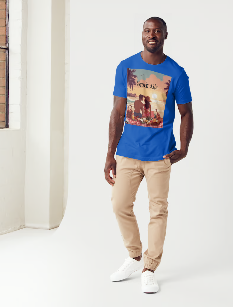 This is a model wearing a t-shirt entitled "Beach Life" men's graphic t-shirt. The shirt itself is blue in color. Made of soft and breathable cotton, this shirt embodies the perfect beach day with a romantic scene full of warm colors, it features a couple enjoying a sunset picnic surrounded by palm trees by the ocean. Let the bold design and adventurous spirit inspire your next adventure!" This is a Mike Roxly collection T-shirt