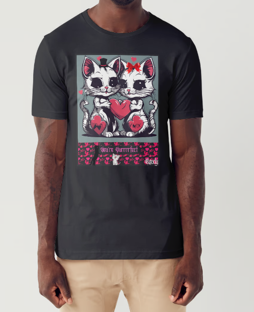 This T-shirt entitled "You're Puurfect", features a cat couple holding a large red heart with heart emojis floating around them showing they're feeling the love in the air. Below them is a banner of pink cupid cut-outs with a black cat leaning on the title "You're Puurfect", with another white cat character with a face of delight sits below the title looking in admiration of the love.