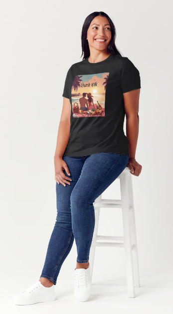 "Embrace adventure in our "Beach Life" cotton tee! This Women's T-shirt is featuring a relaxed fit that transports you to a tropical paradise with its picnic scene of a couple enjoying the sunset over the ocean. Bring the beach life with you wherever you go!" Available in Blue or Black colors.  This is part of the Mike Roxly Collection.